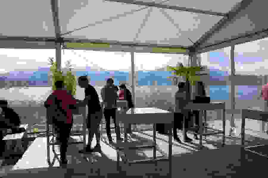 Small groups work on the shore of Lake Lucerne.
