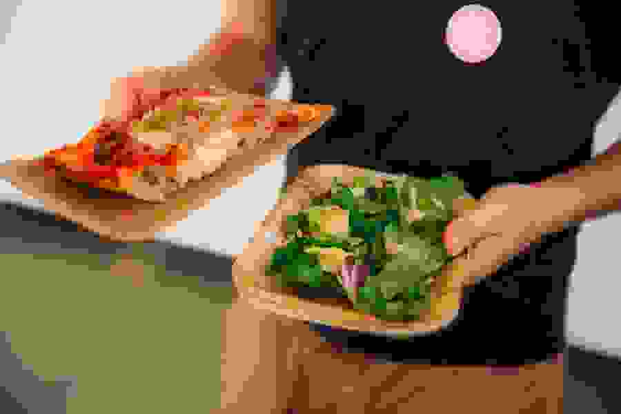Fresh pizza and salad are served at lunch.