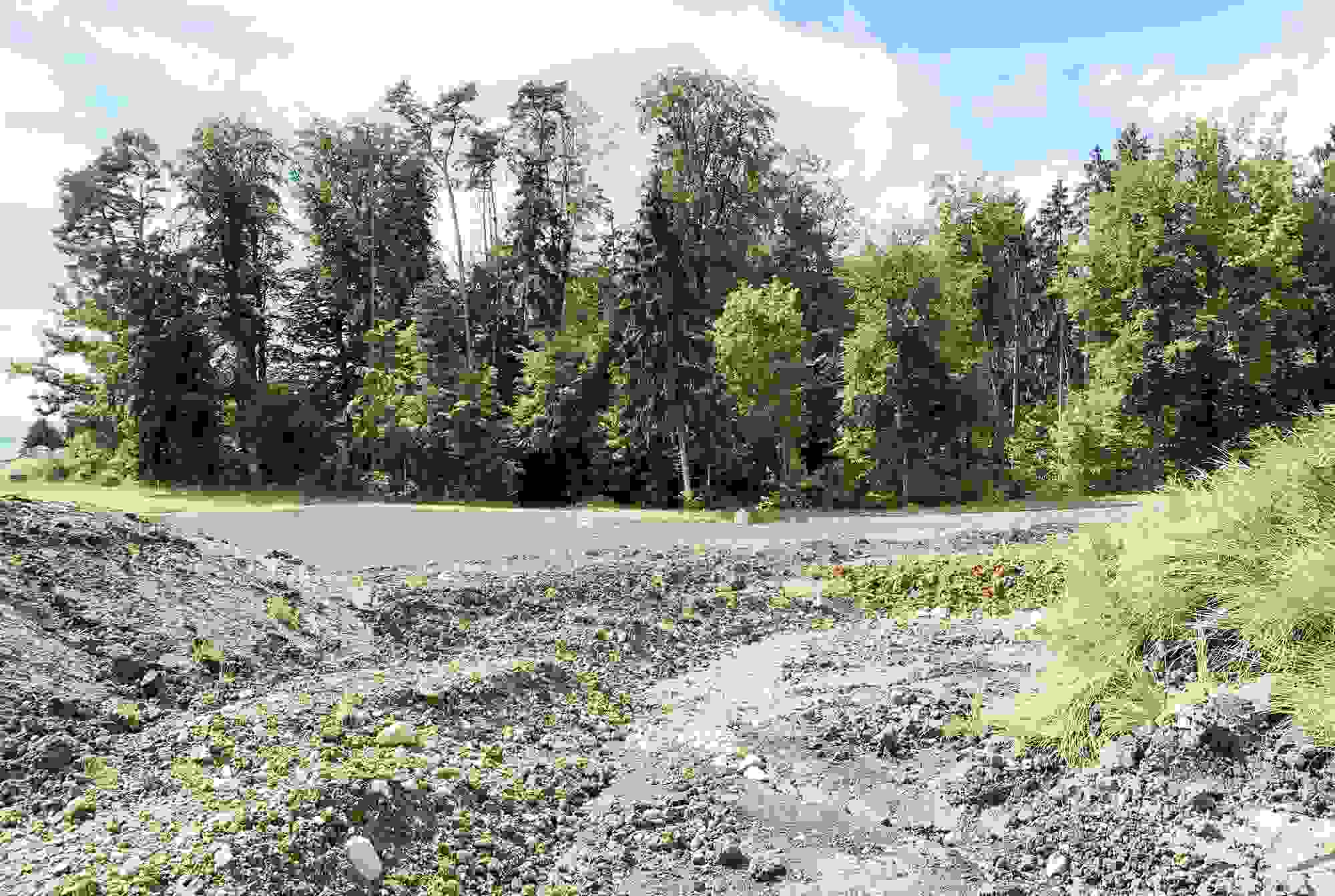 The topsoil and subsoil material is backfilled in strips using a crawler excavator.